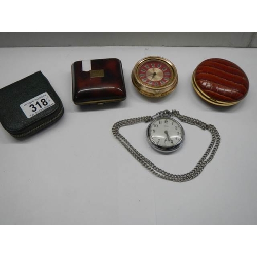 318 - A Smith's pocket watch in working order, 3 other clocks and a pocket watch case,.