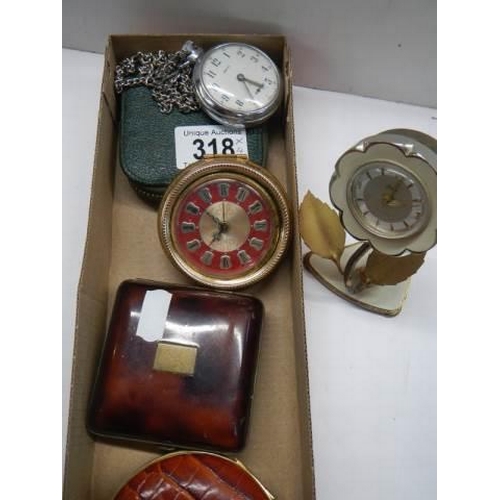 318 - A Smith's pocket watch in working order, 3 other clocks and a pocket watch case,.