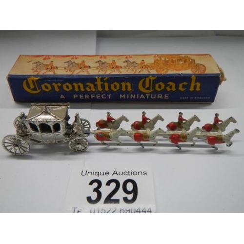 329 - A boxed miniature coronation coach, in good condition.