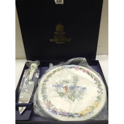 334 - A boxed Royal Worcester porcelain cake plate with cake slice.