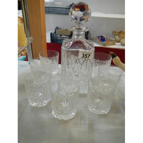 357 - A cut glass decanter and glasses.