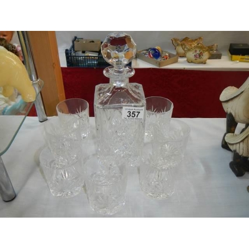 357 - A cut glass decanter and glasses.