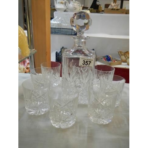 357 - A cut glass decanter and glasses.