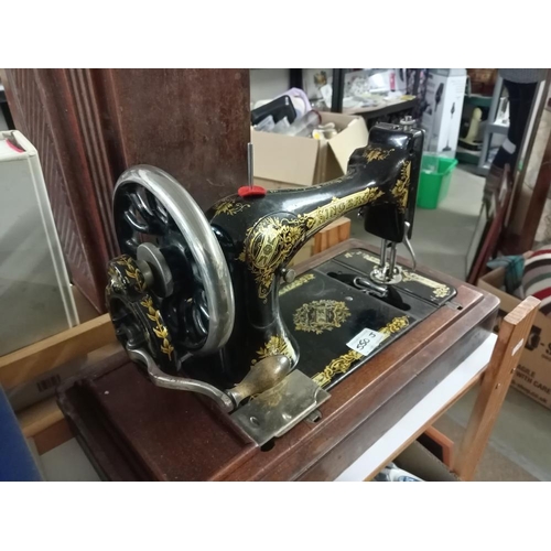 550J - A cased Singer sewing machine