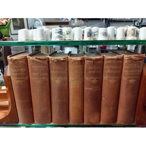 666 - A pair of early 20th century bookends with seven Dickens books.