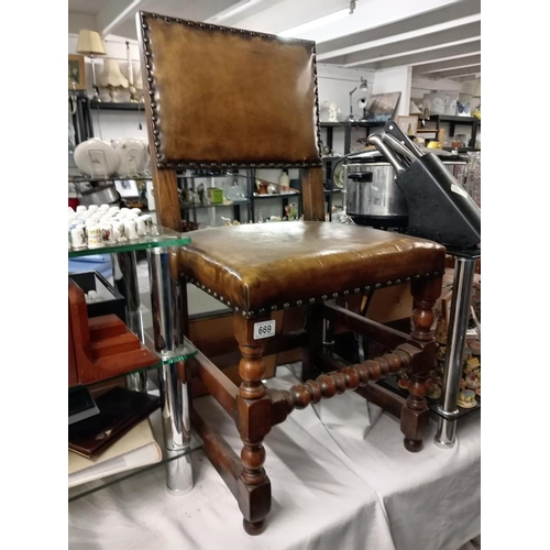 669 - A vintage tan leather chair with oak frame, COLLECT ONLY.