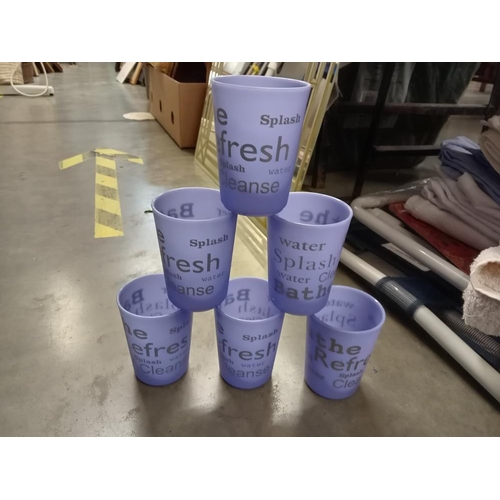 672 - A quantity of more than 70 lilac plastic beakers