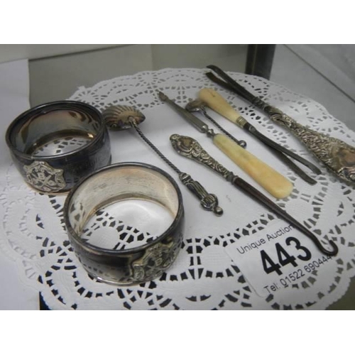 443 - Two silver napkin rings, silver handled button hook and three other items of silver.