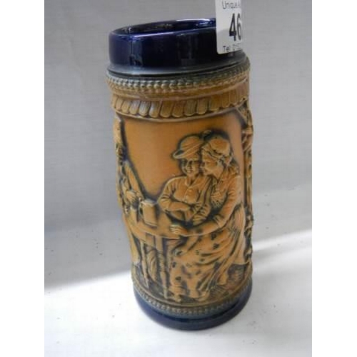 462 - A German beer stein featuring figures.