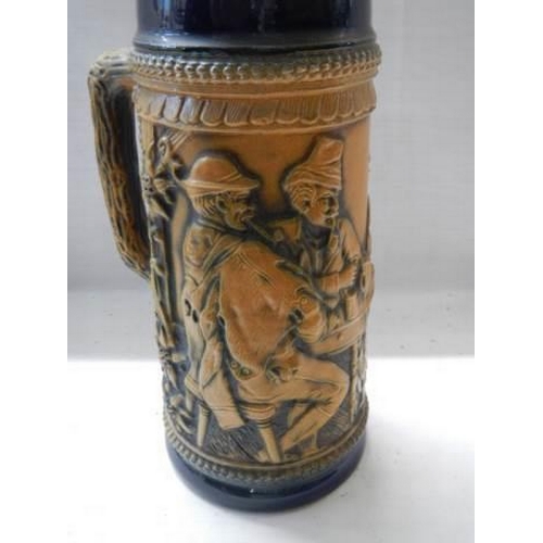 462 - A German beer stein featuring figures.