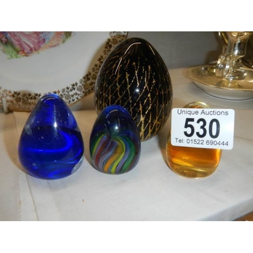 530 - Four good glass paperweights.