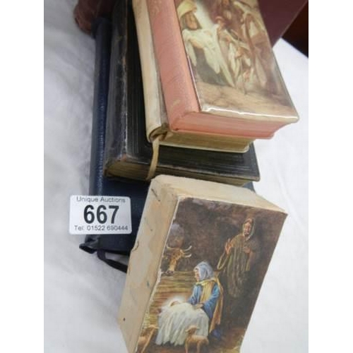 667 - A quantity of old bibles, a crucifix etc.,