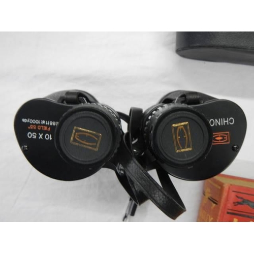 672 - A cased pair of 10 x 50 Chinon binoculars.