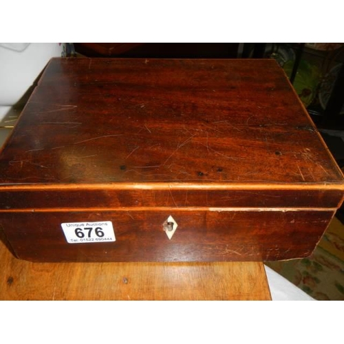 676 - A mahogany box and one other with contents.