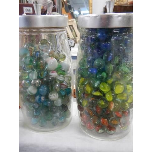 679 - Two jars of old marbles.