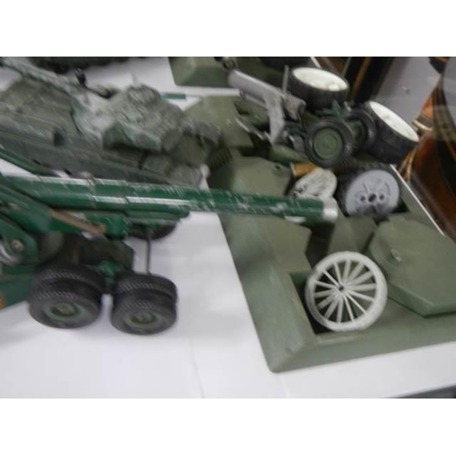 719 - A quantity of military die cast including tanks, field guns etc.,