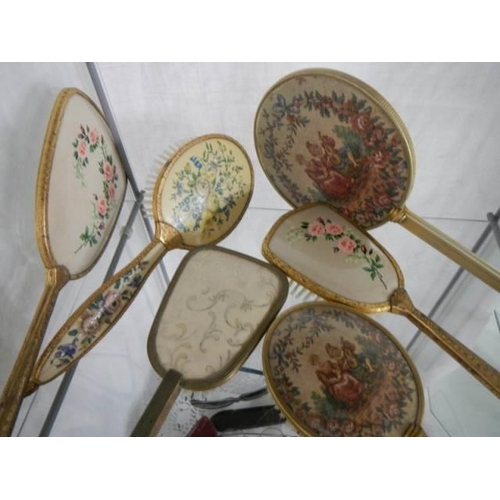 775 - A mixed lot of hand mirrors and hair brushes.