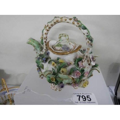 795 - A flower encrusted teapot.