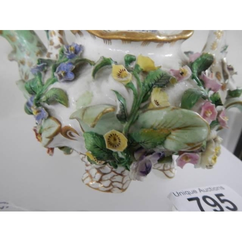 795 - A flower encrusted teapot.