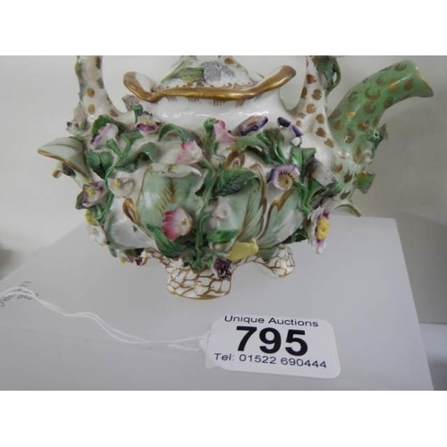 795 - A flower encrusted teapot.