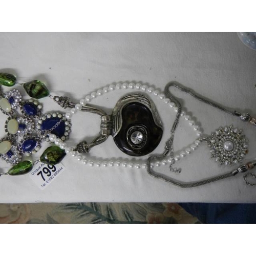 799 - A quantity of necklaces and pendants.