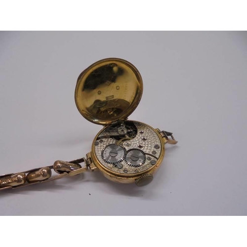 1003 - A 9ct gold ladies wrist watch in working order but bracelet a/f, 18 grams.