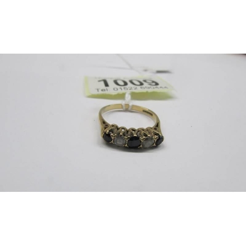 1009 - A 9ct gold five stone ring, size N half, 2.2 grams.