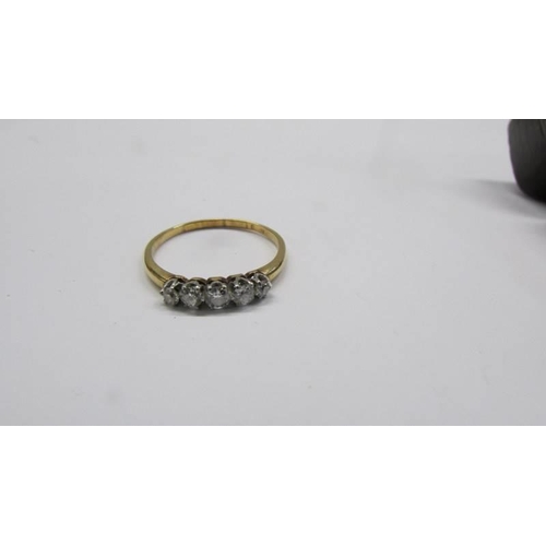 1018 - A five stone diamond ring, hall mark rubbed, size P, 2.1 grams.