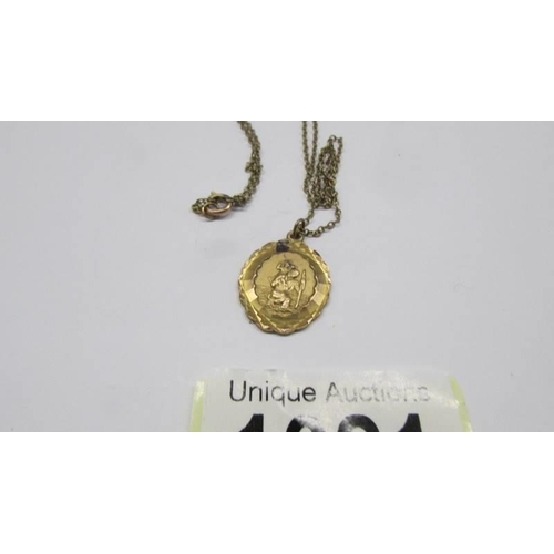 1021 - A 9ct gold St Christopher pendant on chain. 4 grams.