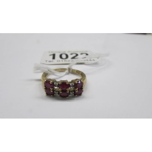 1022 - A 9ct yellow gold high carat diamond and ruby ring, size N half, 2.3 grams.