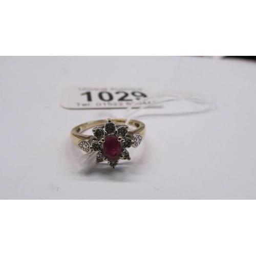 1029 - A 9ct yellow gold ruby and diamond ring, size M, 2.6 grams.