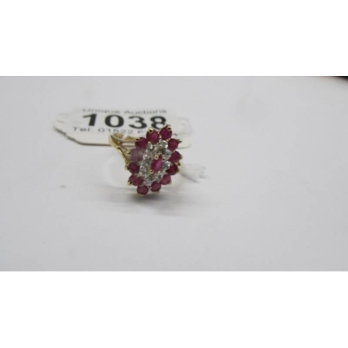 1038 - A yellow gold diamond and ruby ring, size M half, 2.42 grams.