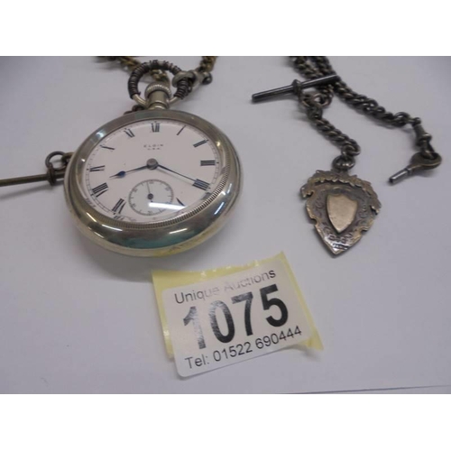 1075 - An Elgin USA pocket watch with various pocket watch chains.