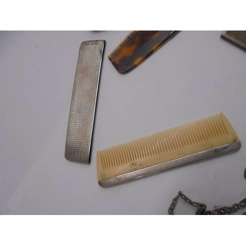 1114 - Two silver cased comb, another comb and two charm bracelets.