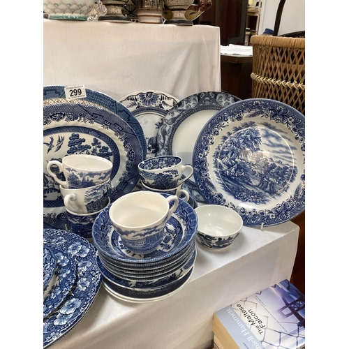 299 - A good quantity of willow & other blue & white china & iron stone items