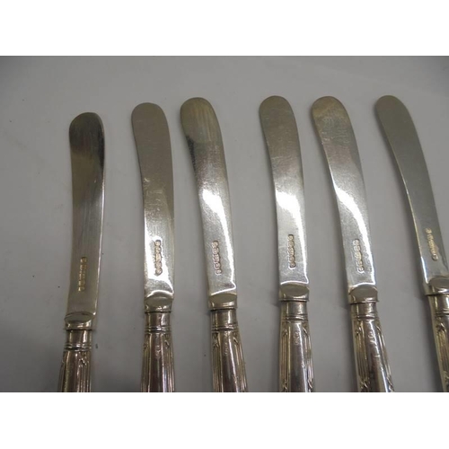 1128 - A set of six silver handled butter knives, I S G Sheffield.