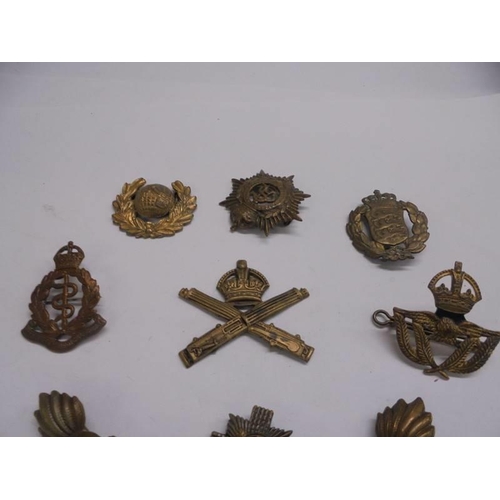 1153 - A quantity of military cap badges including Royal Army Medical Corps.