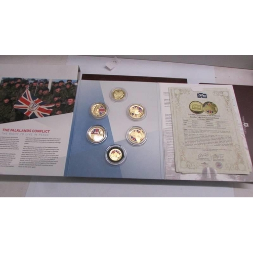 1166 - A case of copper-nickel/gold plated coins, WW1 centenary set, Falklands set etc.,