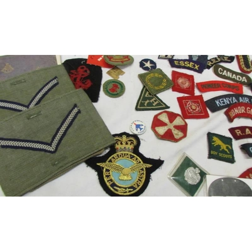 1168 - A large collection of military and other cloth badges including Kenya air force, honor guard, scouts... 