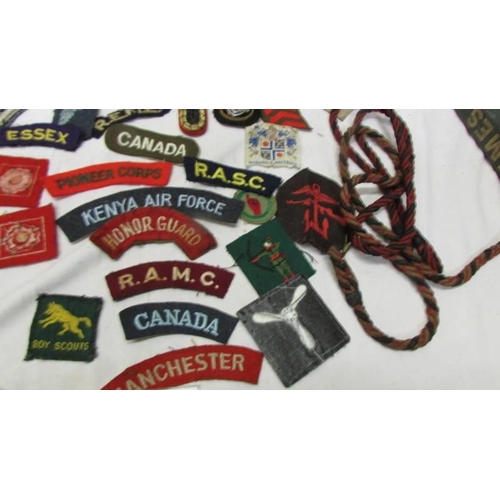 1168 - A large collection of military and other cloth badges including Kenya air force, honor guard, scouts... 