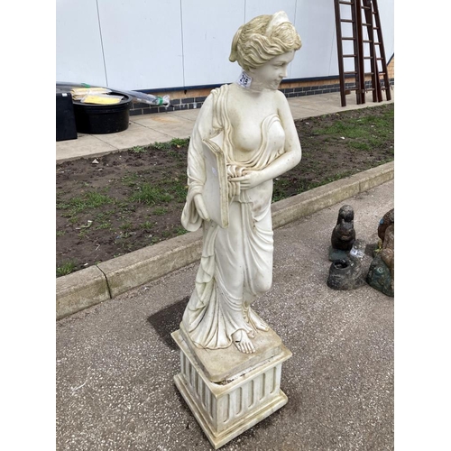 215 - A Lady on a plinth possibly resin. Heavy