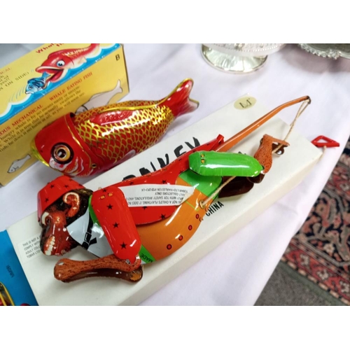 446 - A boxed tinplate climbing monkey whale eating fish & a model workshop