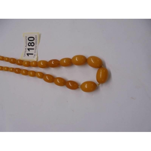 1180 - An amber coloured bead necklace.