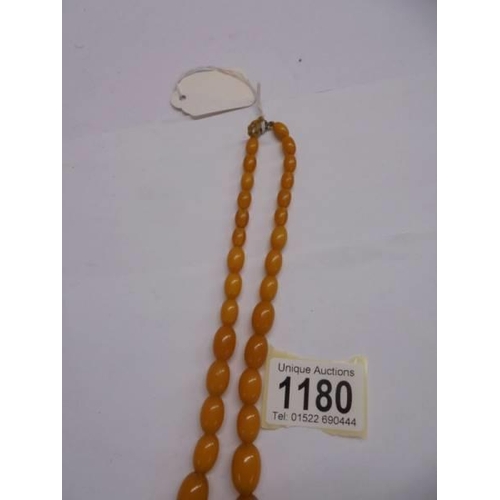 1180 - An amber coloured bead necklace.