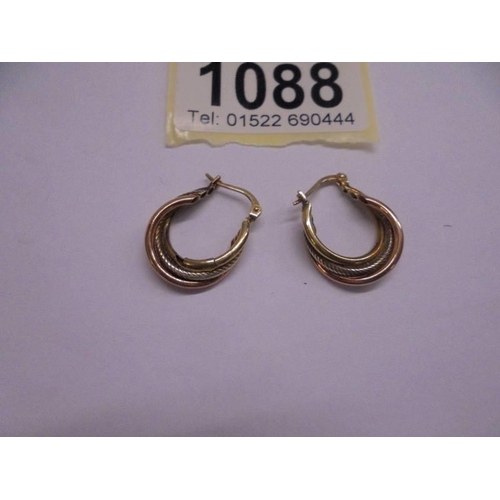 1088 - A pair of 9ct rose, white and yellow gold three hoop earrings.