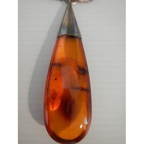 300 - An amber pendant, two agate pendants, two agate brooches etc.,