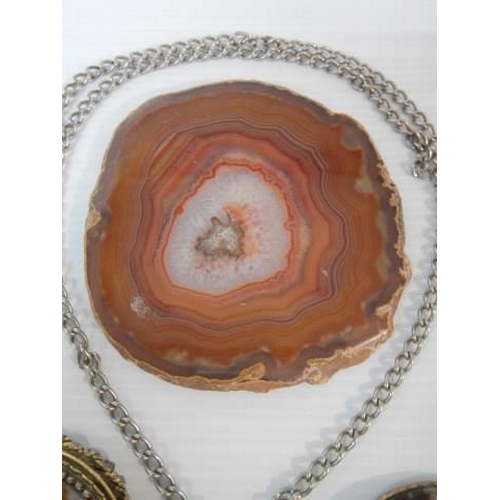 300 - An amber pendant, two agate pendants, two agate brooches etc.,