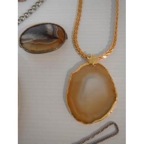 300 - An amber pendant, two agate pendants, two agate brooches etc.,