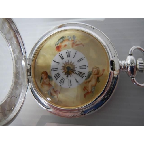 304 - A 20th century silver plate pocket watch featuring cherubs, in working order.