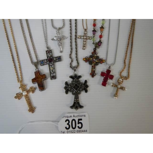 305 - Nine assorted cross pendants.